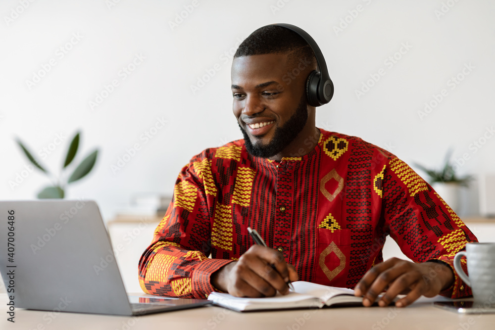 Distance Learning. Happy Black Millennial Guy Study Online With Laptop And Headset - obrazy, fototapety, plakaty 