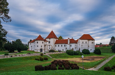 Wall Mural - Sunrise at city park and old castle in Varazdin city, Croatia. September cloudy morning, 2020