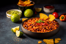 Mexican Hot Chili Con Carne In A Bowl With Tortilla Chips On Dark Background