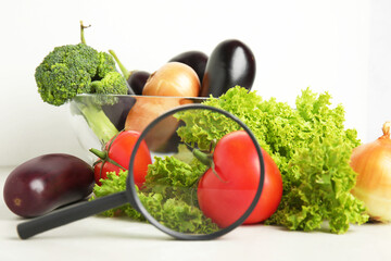 Wall Mural - different fresh vegetables and magnifying glass on table. poison detection