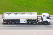 © aapsky - Fuel Truck Drives on the highway with a tank trailer.