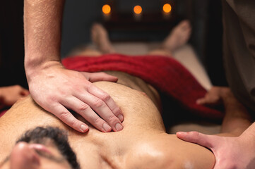 Sports massage. Breast massage. Physiotherapist doing a male breast massage to an athlete to a patient. Close-up