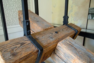 Detail of a wooden cross, which is fastened in iron hoops.