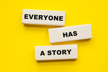 Wall Mural - words EVERYONE HAS A STORY written on cubes . You can use in business, marketing and other concepts.