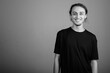 © Ranta Images - Young handsome man wearing black shirt against gray background
