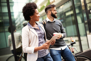 Business people discussing and smiling while walking together outdoor