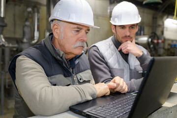 two engineers working on a laptop