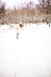 © Ирина Ваганова - Girl running and playing in the park on a snowy day