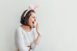 Happy Easter holiday celebration spring concept. Young woman wearing bunny ears isolated on white background. Preparation for holiday. Girl looking happy and excited having fun on Easter day