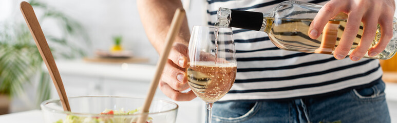 cropped view of man pouring wine in glass, banner