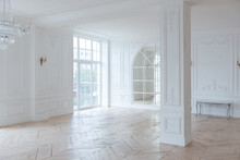 Chic White Huge Spacious Hall With A Minimum Of Expensive Antique Furniture. Baroque Interior Design With Ornament On The Walls And Parquet On The Floor.