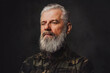 © Fxquadro - Brutal martial grandfather dressed in military clothing poses in dark background. Headshot of old man.
