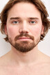 © Roman - serious male with long hair and beard posing at camera, half-naked man looks at camera, half-naked. isolated white backrgound