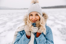 Closeup Portrait Of A Young Blonde Woman Looking At Camera, On Cold Winter Day.