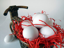 White Chicken Eggs Lie In A Basket Stylized Under A Vintage Bike