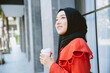 © Quality Stock Arts - Arab Muslim Asian businesswoman young girl smiling hand hold coffee cup standing portrait