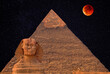 Giant statue of Great Sphinx on the background of oldest and largest Pyramid of Giza (Pyramid of Cheops), bank of Nile river, Cairo, Egypt; fabulous atmosphere of night with full moon and starry sky