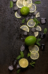 Sticker - Fresh mint, lime and ice on a black background. Ingredient for mahito.