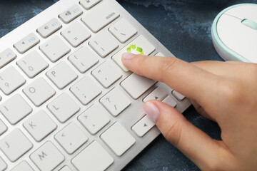 Woman pressing key on keyboard, closeup. Ecology concept