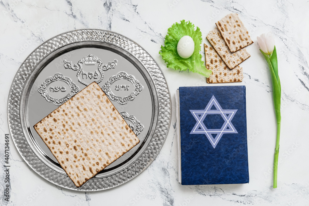 Passover Seder plate with traditional food and Torah on white background