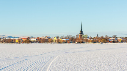 Wall Mural - snow covered frozen lake in Swedish town of Mora in winter