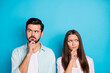 © deagreez - Photo of pensive hesitant man and woman look empty space hand chin wear shirt isolated on blue color background