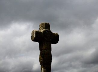 stone cross on the background of blue sky