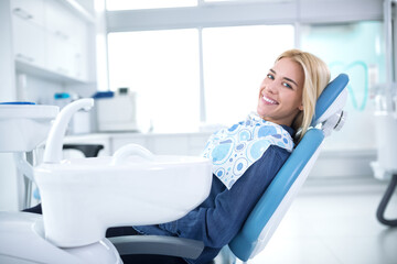 Smiling and satisfied patient in a dental office