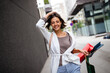 Portrait of beautiful smiling young woman with shopping bags