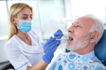 A young female dentist controls the health of the tooth