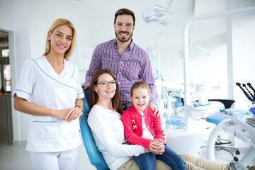 Family with a smiling young dentist