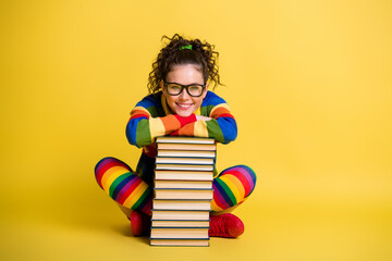 Canvas Print - Photo of diligent student lady sitting floor lean book pile legs crossed wear striped rainbow clothes isolated yellow color background