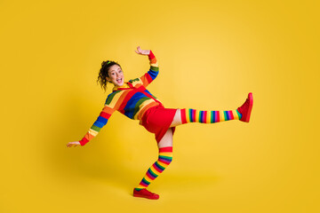 Wall Mural - Profile photo of funky lady raise leg clubber party dj wear striped sweater short skirt knee socks shoes isolated yellow color background