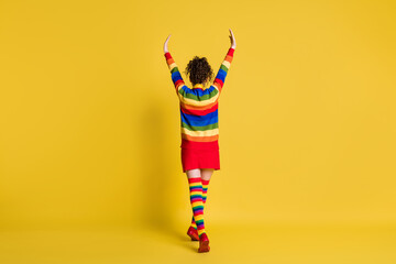 Canvas Print - Behind back view photo of lady making step wear striped pullover short skirt knee socks shoes isolated yellow color background