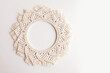 Macrame mandala. Macrame wreath on a white background close up. Natural cotton thread. Eco home decor. Copy space