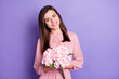 © deagreez - Portrait of nice cute cheerful girl holding in hands pink flowers isolated over bright violet color background