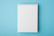 © ActionGP - Above flat lay overhead close up view photo of clear open spiral notepad for letter document isolated light backdrop