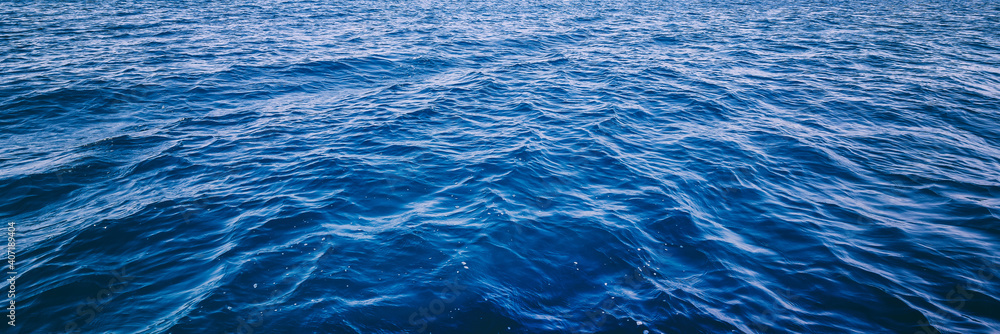 Blue deep sea ocean water in calm, banner format - obrazy, fototapety, plakaty 