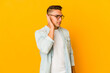 © Asier - Young handsome caucasian man isolated trying to listening a gossip.