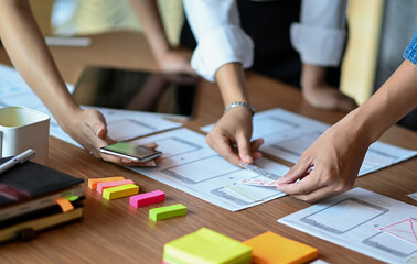 Designers develop new mobile applications, ui ux design team planning and analyzing mobile applications.