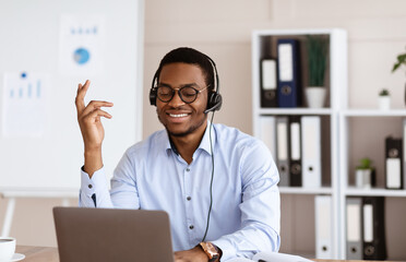 Positive african young man having business conference in office