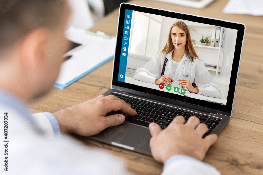 Online medical consultation. Male patient communicating to his doctor on laptop at home - obrazy, fototapety, plakaty 