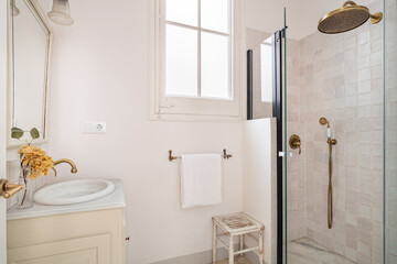 Interior of retro style bathroom with shower zone and sink, decorated in beige color.