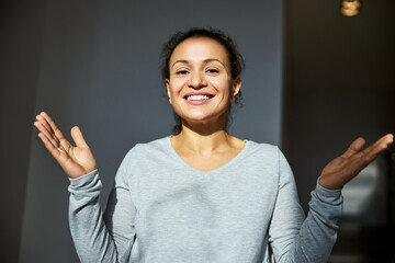 woman in a grey shirt holding hands apart