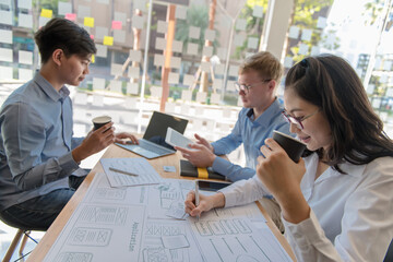 Creative graphic designers team draft planning application development process prototype layout for mobile web. User Experience Concepts