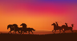 Fototapeta Konie - cowboy and cowgirl riders chasing mustang horses herd and throwing lasso - romantic wild west sunset landscape scene vector silhouette design