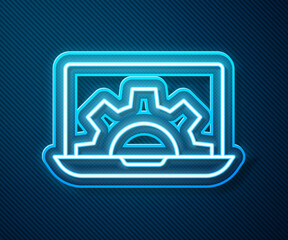 Glowing neon line Software, web development, programming concept icon isolated on blue background. Programming language and program code on screen laptop. Vector.