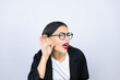 © Irene - Beautiful business woman surprised with hand over ear listening an hearing to rumor or gossip