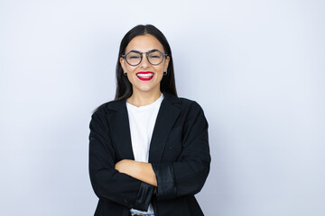 Young business woman standing and smiling with a confident smile showing teeth with arms crossed