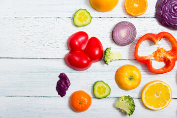 Wall Mural - sliced fruit and vegetable circles on white wood table